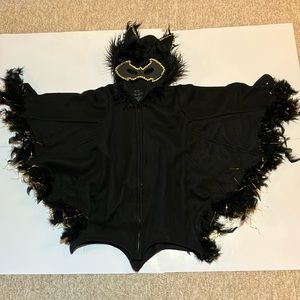 Original modified with gold jewels, threads, black feathers, and mask